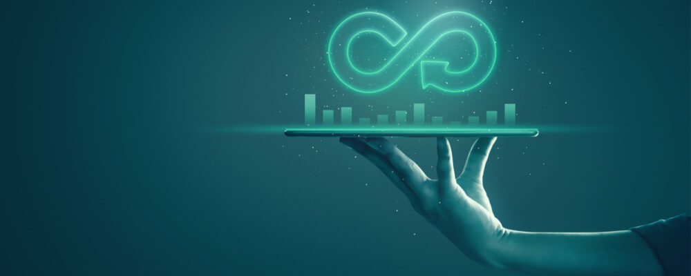 Circular economy with infinite concept. Business man showing arrow infinity symbol with neon light and dark background. Graph showing the earnings, profits of business shares in good feedback.