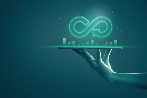 Circular economy with infinite concept. Business man showing arrow infinity symbol with neon light and dark background. Graph showing the earnings, profits of business shares in good feedback.